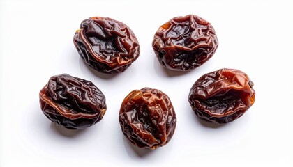 Five dried raisins with wrinkled texture on white background
