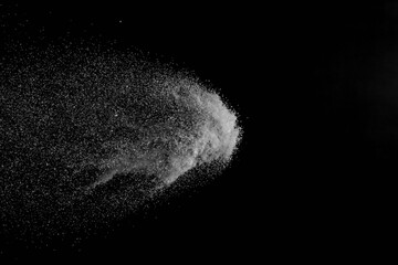 The falling white snow on a black background