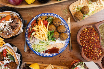 Middle eastern feast platter with falafel, kebab, and spices