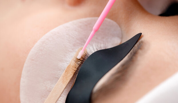 Eyelash removal beauty procedure with tools and pads macro photo