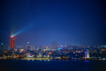 Da nang skyline at night with illuminated buildings and starry sky