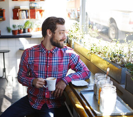 Calm, thinking or man in coffee shop with happiness, mindset or satisfied in morning routine. Reflection, relax and male person in cafe with mug, mood improvement or mindfulness at start of day.