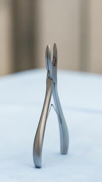 Close-up of a sterile surgical instrument, bone rongeur, on a clean surface.