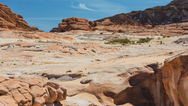 landscape of rocky mountains and desert and sky on a sunny day in Egyp