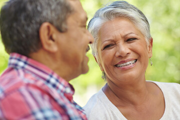 Obraz premium Outdoor, love and senior couple with smile for bonding together, commitment and trust for connection. Retirement, care and elderly people in park on weekend, wellness and happiness in relationship
