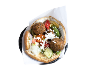 Falafel pita sandwich with vegetables and feta cheese