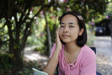 Woman applying skin care cream and sunscreen.