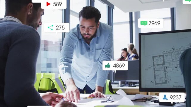 Standing man pointing and adjusting plans for review, causing alerts drifting across design studio