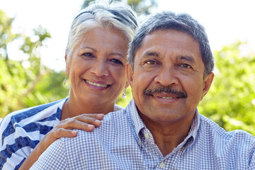 Hug, portrait and smile with old couple in park together for bonding, retirement or romance. Happy, love and marriage with senior people outdoor in garden or nature for commitment and wellness
