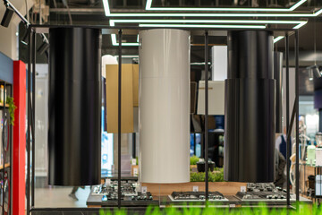 An eye-level shot of modern cylindrical range hoods