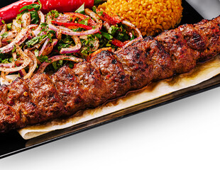 Delicious kebab served with rice and fresh salad at a local restaurant