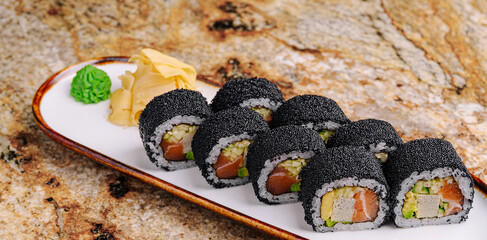 Unique sushi rolls displayed on a plate with wasabi and ginger © AntAlexStudio