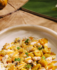 Delicious pasta dish with chicken and vegetables served in a cozy setting