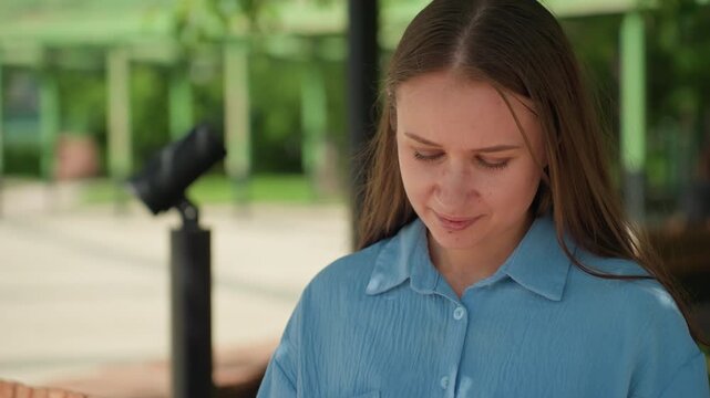 teacher examining schedule outside, female instructor studying course plan outdoors at campus, educator carefully analyzing syllabus while seated on park bench amidst lush campus surroundings