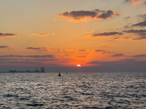 Ocean landscape sunset with distant Dubai cityscape view