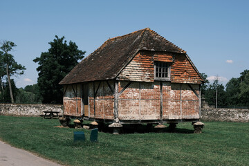 Traditional English Timber-Framed Stilt House or Granary on Staddle Stones on Cowdray Estate, Easebourne, West Sussex