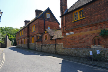 Red Brick Terrace Houses with Yellow Window Frames and Stone Wall on St Annes Hill, Midhurst