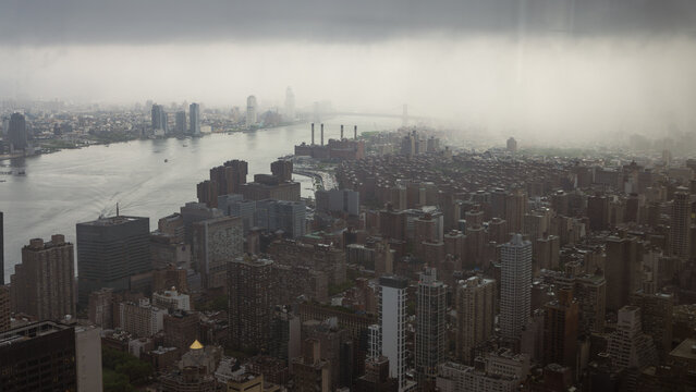 City Skyline in Misty MorningMisty cityscape with high-rise buildings near the river, creating a serene and atmospheric urban view.city