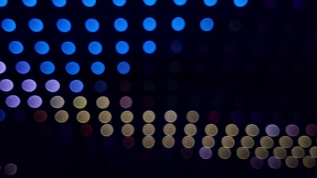 Defocused bokeh background with colorful LED lights at the night club
