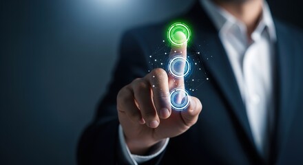 A businessman's hand interacting with a glowing green virtual button on a dark background, indicating selection or activation.
