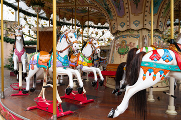 Christmas market in Trier, Germany, carousel with horses, roundabout for children, advent time in winter season, november 30th 2025