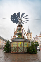 Christmas market in Trier, Germany, wood carving pyramid, fir tree with baubles and light, advent time in winter season, november 30th 2025