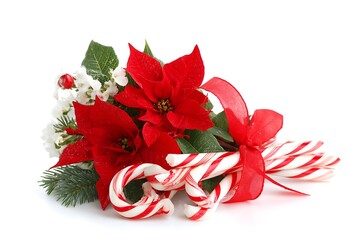 Festive christmas arrangement with poinsettia and candy cane isolated on white