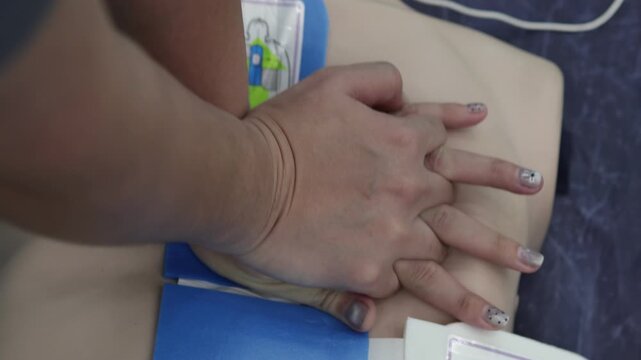 CPR training chest compression first aid emergency response hands only medical mannequin lifesaving healthcare safety instruction practice resuscitation technique nurse paramedic clinic hospital 