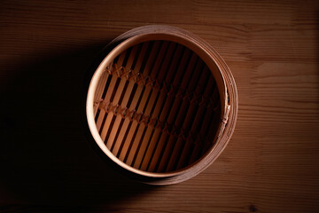 empty dim sum bamboo steamer on wood background