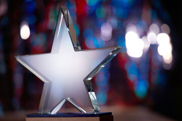 crystal star shape trophy against bokeh light as background