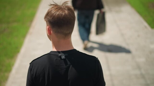 transient moment between pedestrian and visitor outside, fleeting exchange occurring during vibrant summer city scene, ephemeral interaction shared briefly amid lively urban summer environment