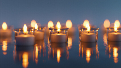 Softly glowing tealight candles float on a dark reflective surface creating a serene and peaceful ambiance with warm light Worldwide Candle Lighting