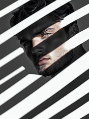 A young man with a beard is partially visible behind a series of white blinds, with dramatic lighting creating shadows across his face.