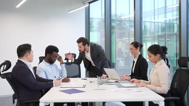 Angry boss scolds a group of subordinates for poor work results at a meeting in the boardroom. Dissatisfied manager quarreling incompetent workers. Furious CEO director arguing talking about problems