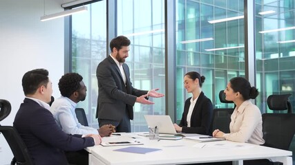 Male CEO praises female employee for excellent job during meeting in boardroom. Happy diverse team of co-workers support colleague with applause, clapping hands, celebrate success and great results - Powered by Adobe