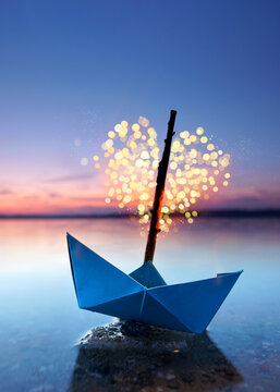 Fototapeta magical blue paper boat with lantern at the beach - romantic evening