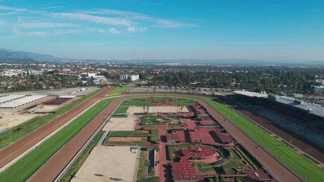 Aerial wide reverse pullback shot of the horse racing track at Santa Anita Park in Arcadia, California. 4K