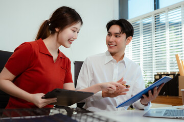 financial asian advisor showing plan of investment to clients in the consultancy office.
