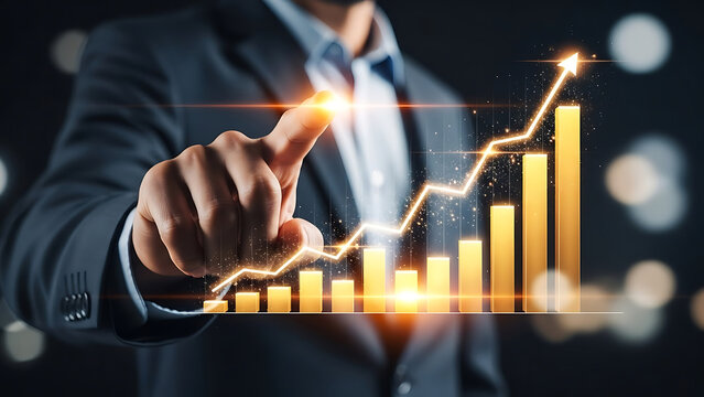 A businessman pointing at a golden bar graph with an upward trending arrow on a dark background