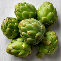 Obraz premium Fresh green artichokes arranged on a light background.