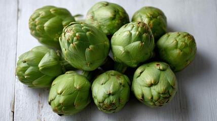 Fototapeta premium Close-up of fresh green artichokes on rustic wooden table.