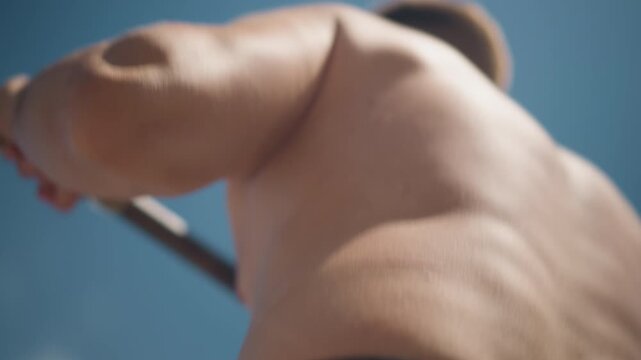 muscular man performing outdoor pullup exercise, strong male athlete engaged in outdoor pullup in street gym, caucasian male demonstrating intense pullup exercise in openair gym setting