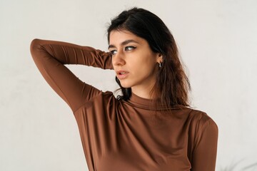 Close-up portrait of a woman in a brown dress