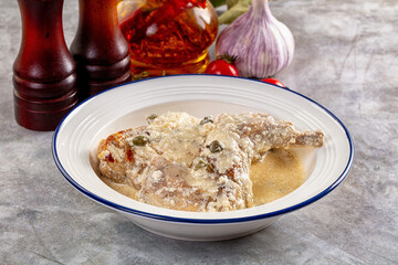 Roasted rabbit legs in cream sauce
