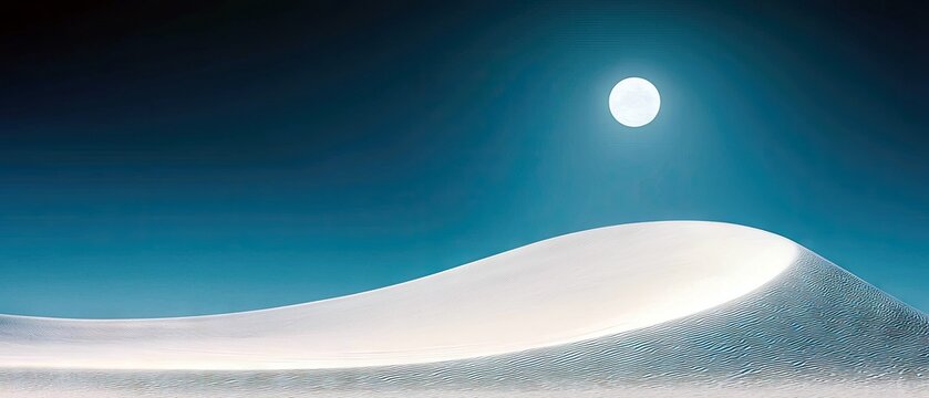 A panoramic view of a white sand dune under a bright full moon in a dark blue sky at night.