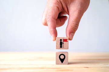 Goal Achievement and Strategic Direction Concept with Hand Placing Wooden Block Featuring Flag and Location Pin Icon