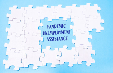 Puzzle pieces forming message about pandemic unemployment assistance on blue background