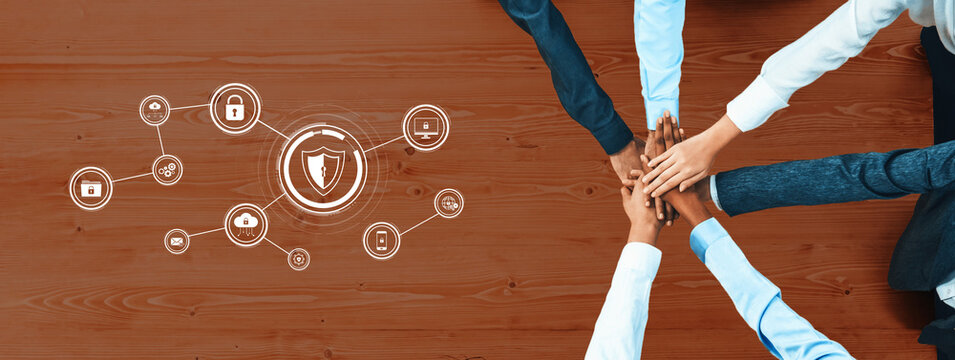 A group of diverse professionals join hands in a team collaboration effort, symbolizing unity and shared goals in developing cybersecurity solutions for digital protection. Trope