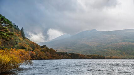 Stormy autumn view of Muckross Lake, Killarney National Park, Co. Kerry, Ireland, mountains, forest, textured water