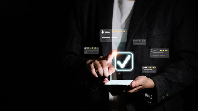 Business person touching virtual check mark and five star rating for customer satisfaction.